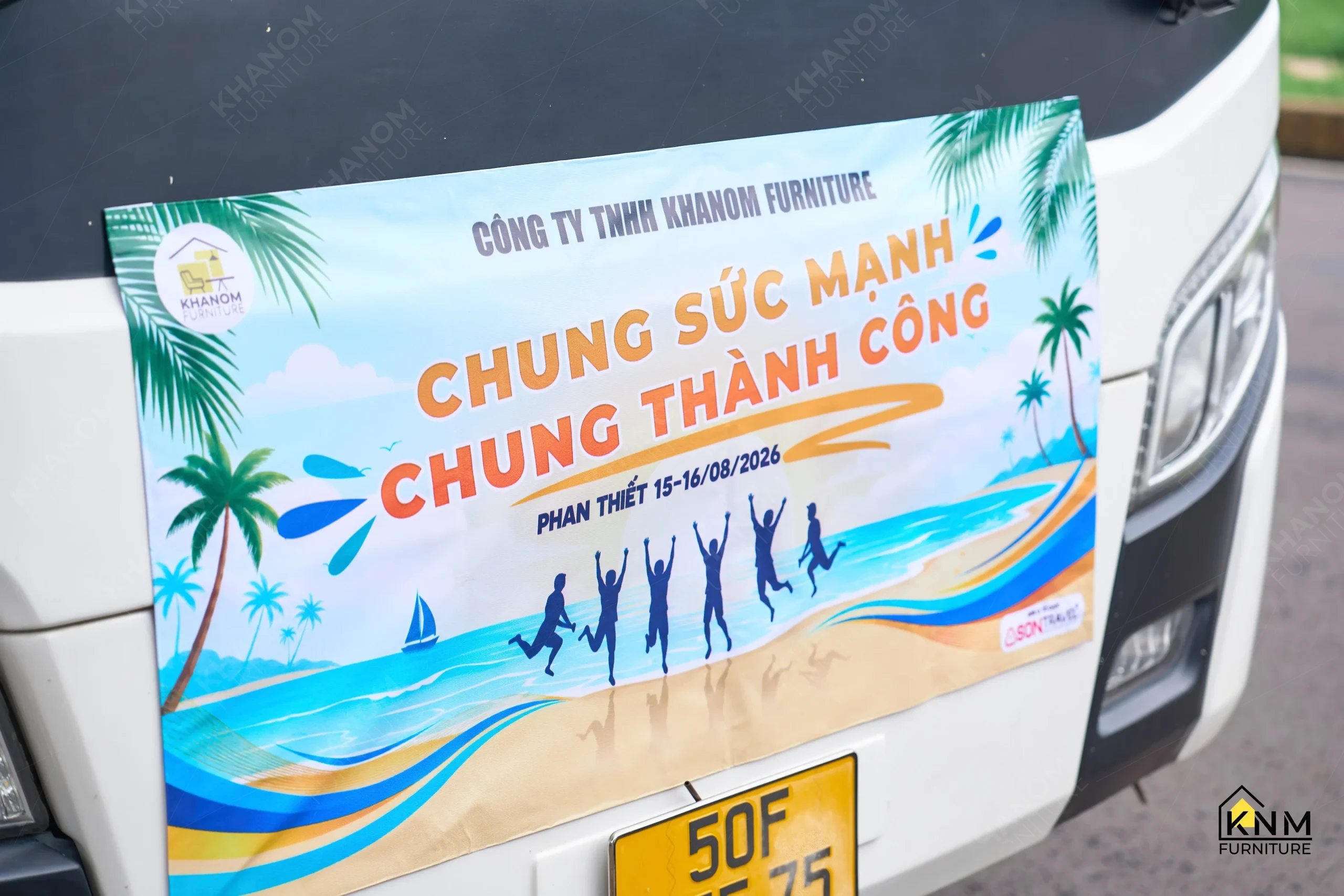 KNM Furniture team building 2026 event banner on charter bus, Phan Thiết