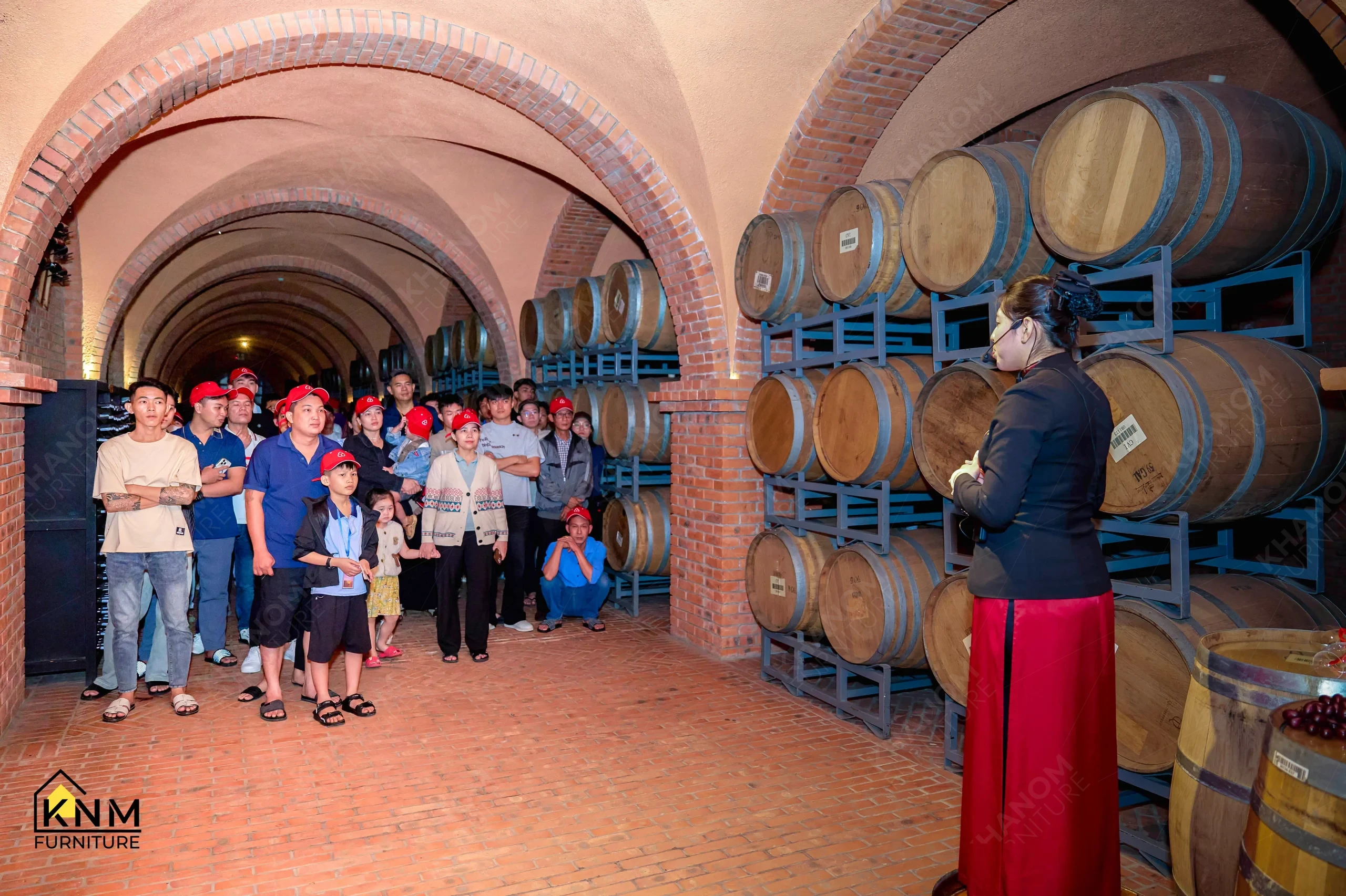 KNM Furniture team on guided wine cellar tour during team building trip