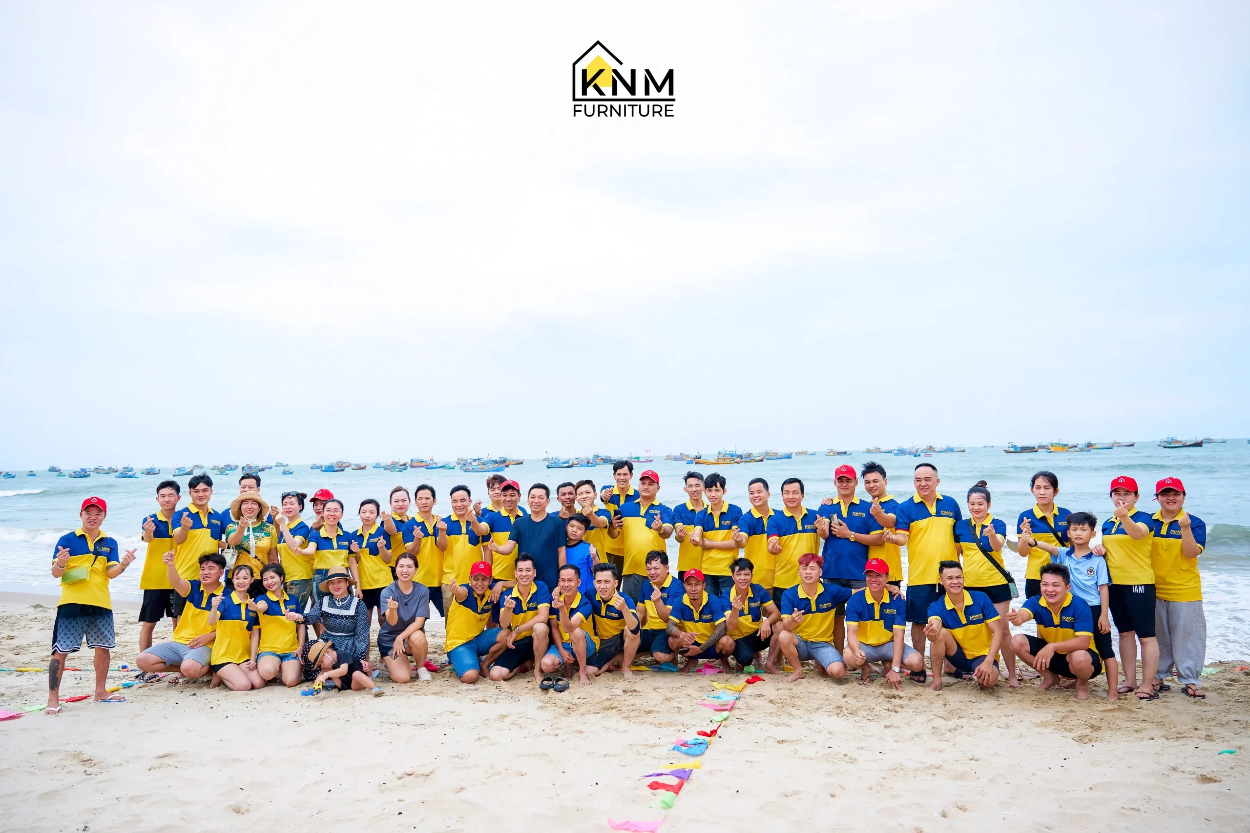 KNM Furniture full team group photo on Phan Thiết beach