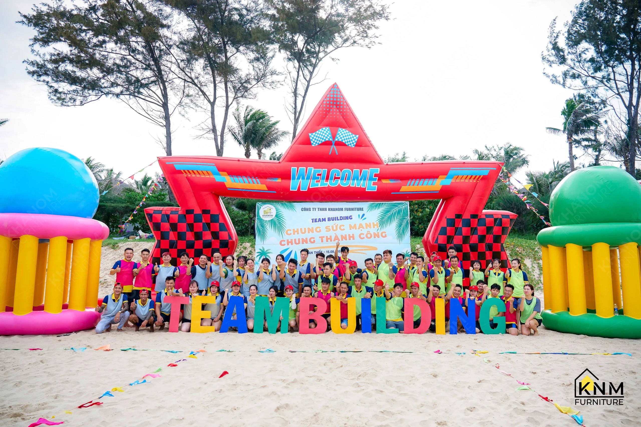 Combined KNM Furniture teams gathered at Welcome Arch, team building 2026